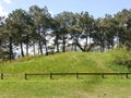 Partial view of a burial mound in Brittany France , grass-covered , the Neolithic megalithic culture